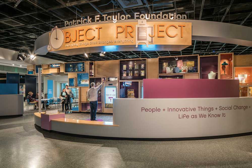 A museum exhibit featuring a large sculpture made of wooden display cases stacked together.